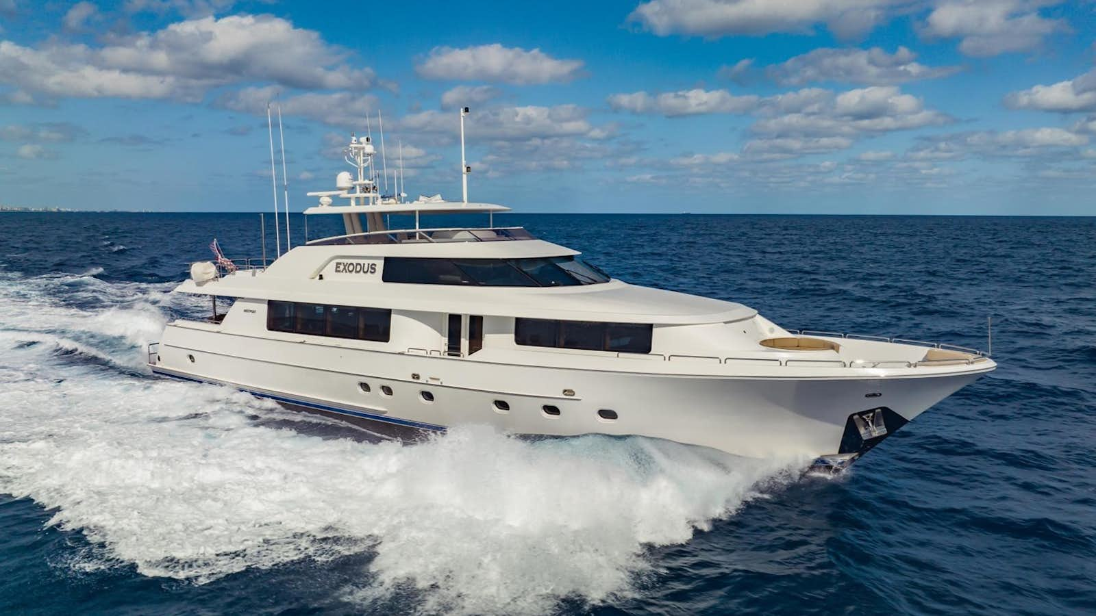 a white boat on the water aboard EXODUS Yacht for Sale