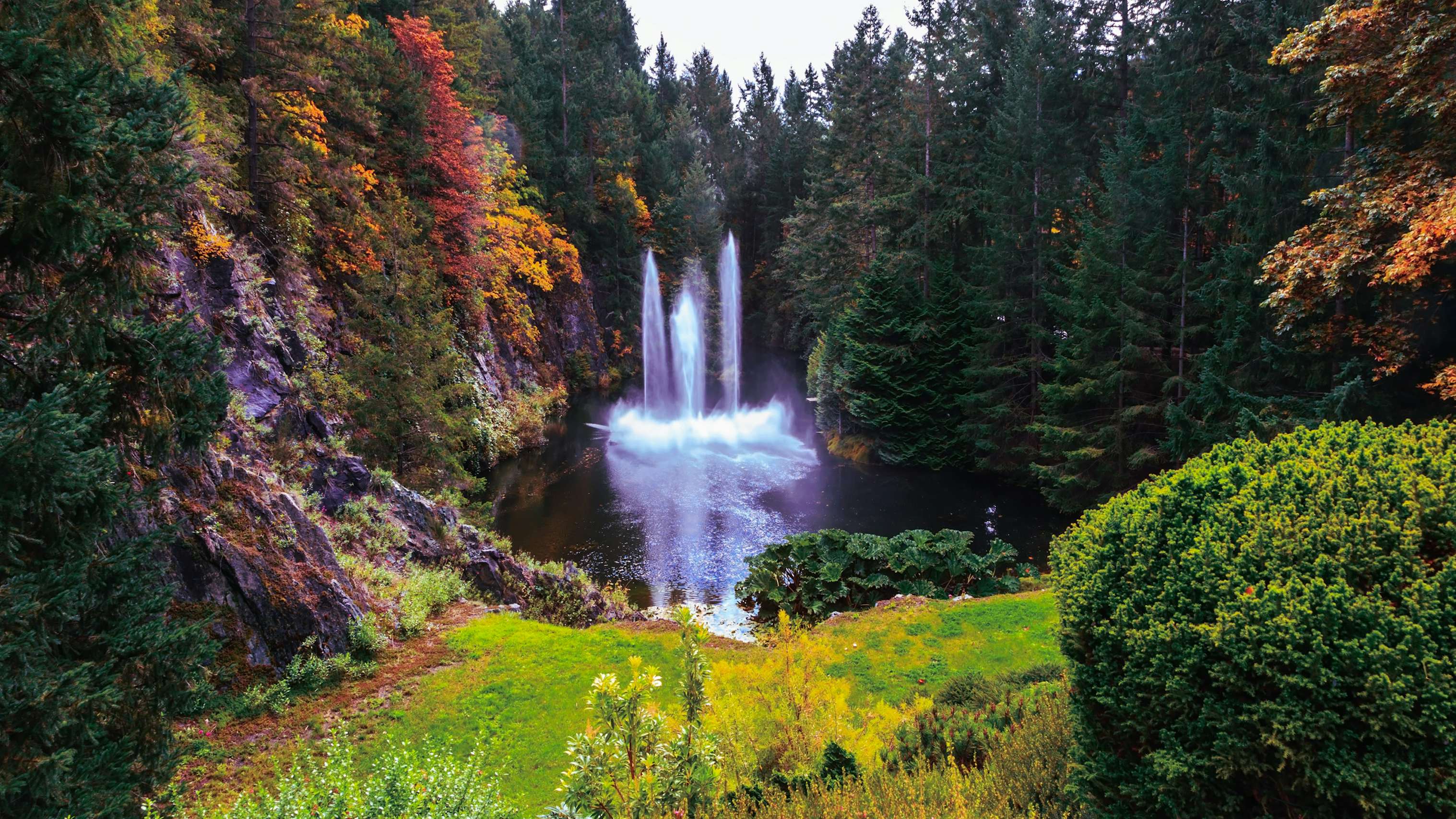 Pacific Northwest Yacht Charter - Butchart Gardens on Vancouver Island, Canada. Dancing fountain in a quiet pond. Autumn day in the park