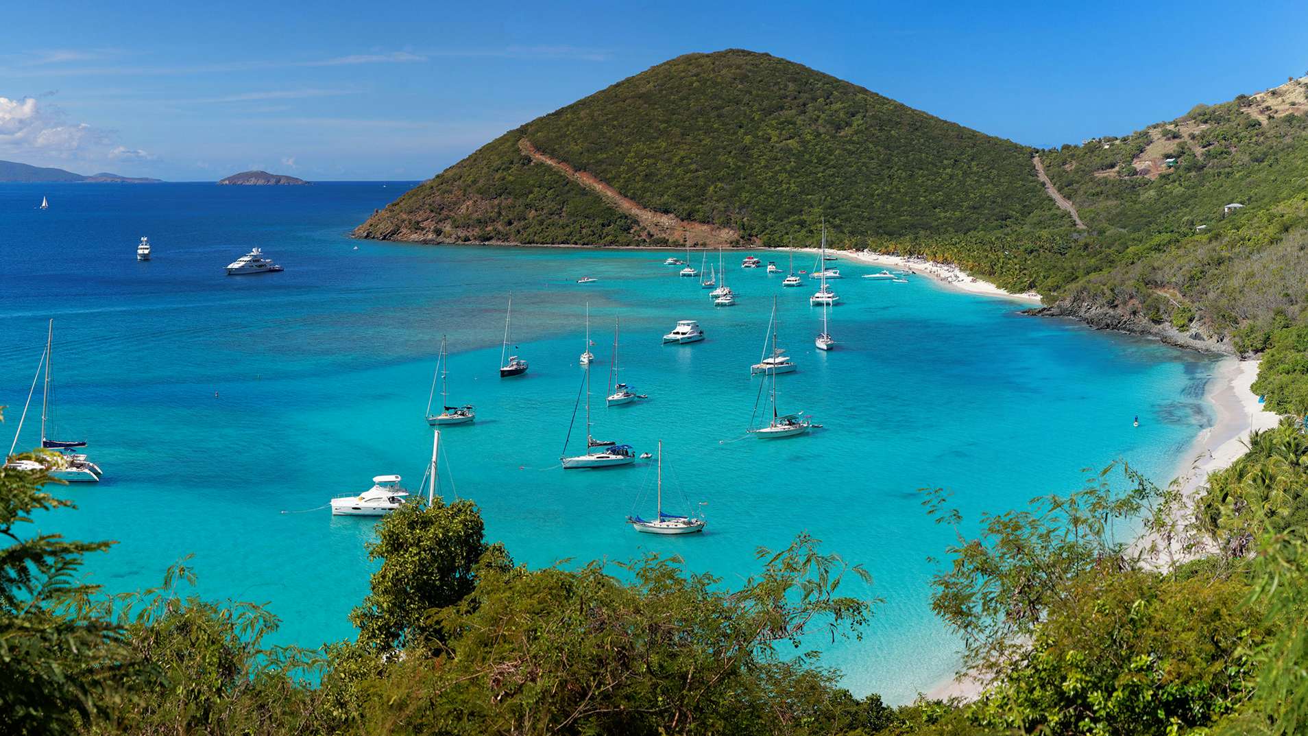 A breathtaking panoramic view of the tropical shoreline in the British Virgin Islands (BVI), Caribbean—a perfect scene for your Yacht Charter adventure.