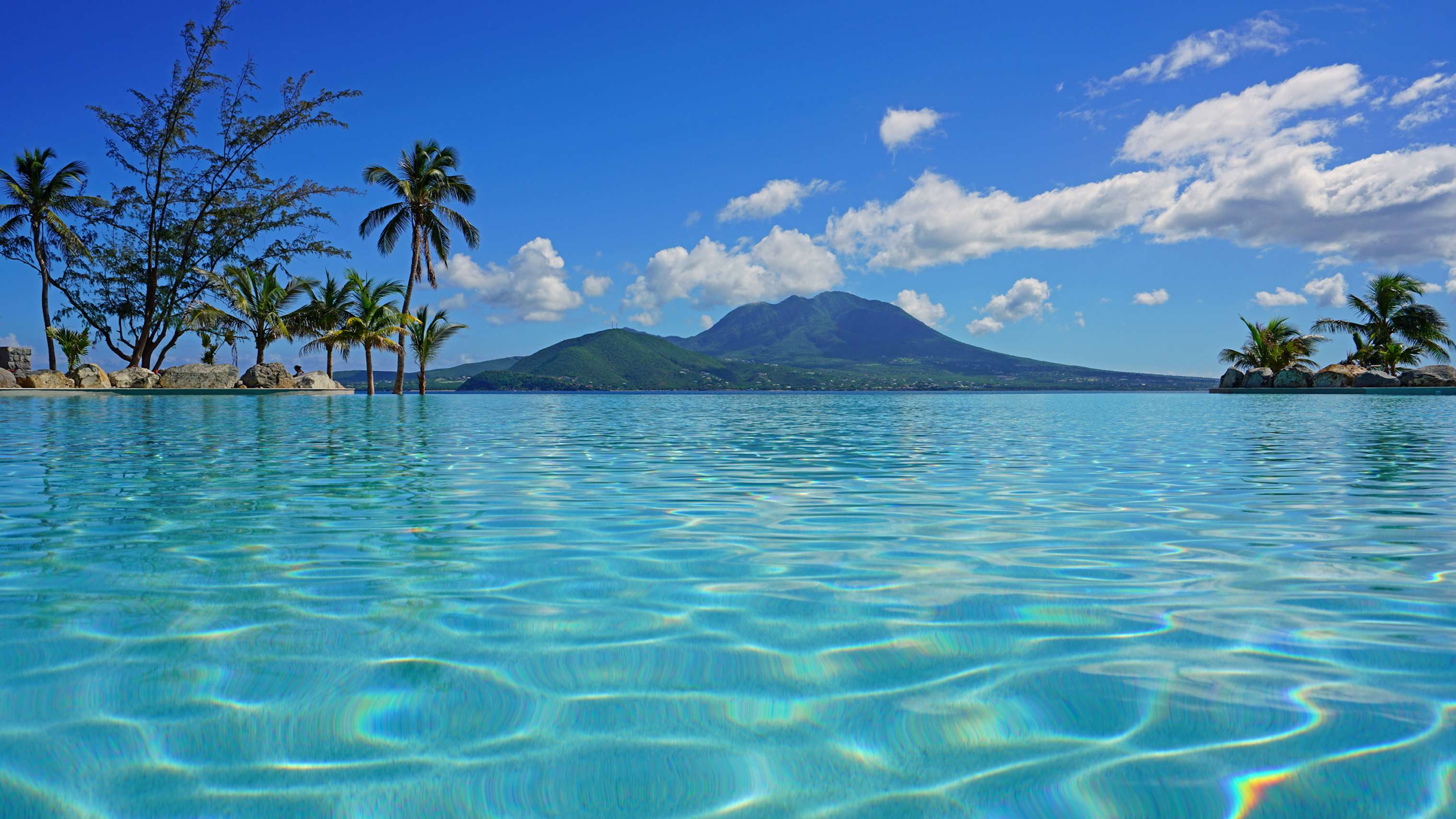 A captivating scene of turquoise blue waters surrounding isolated land in St. Kitts, a perfect yacht charter destination in the Leeward Islands.