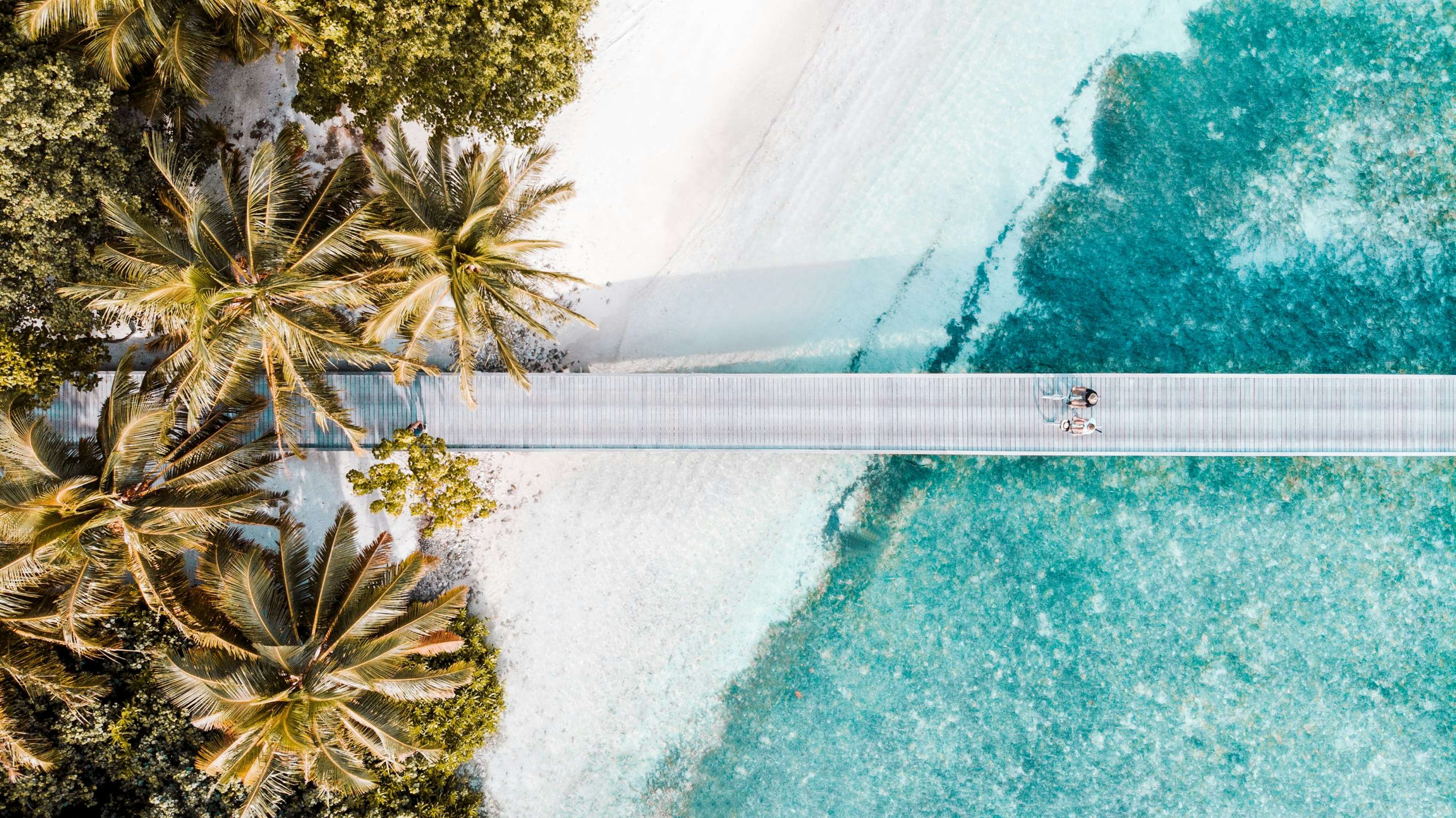 Pier on white sand beach