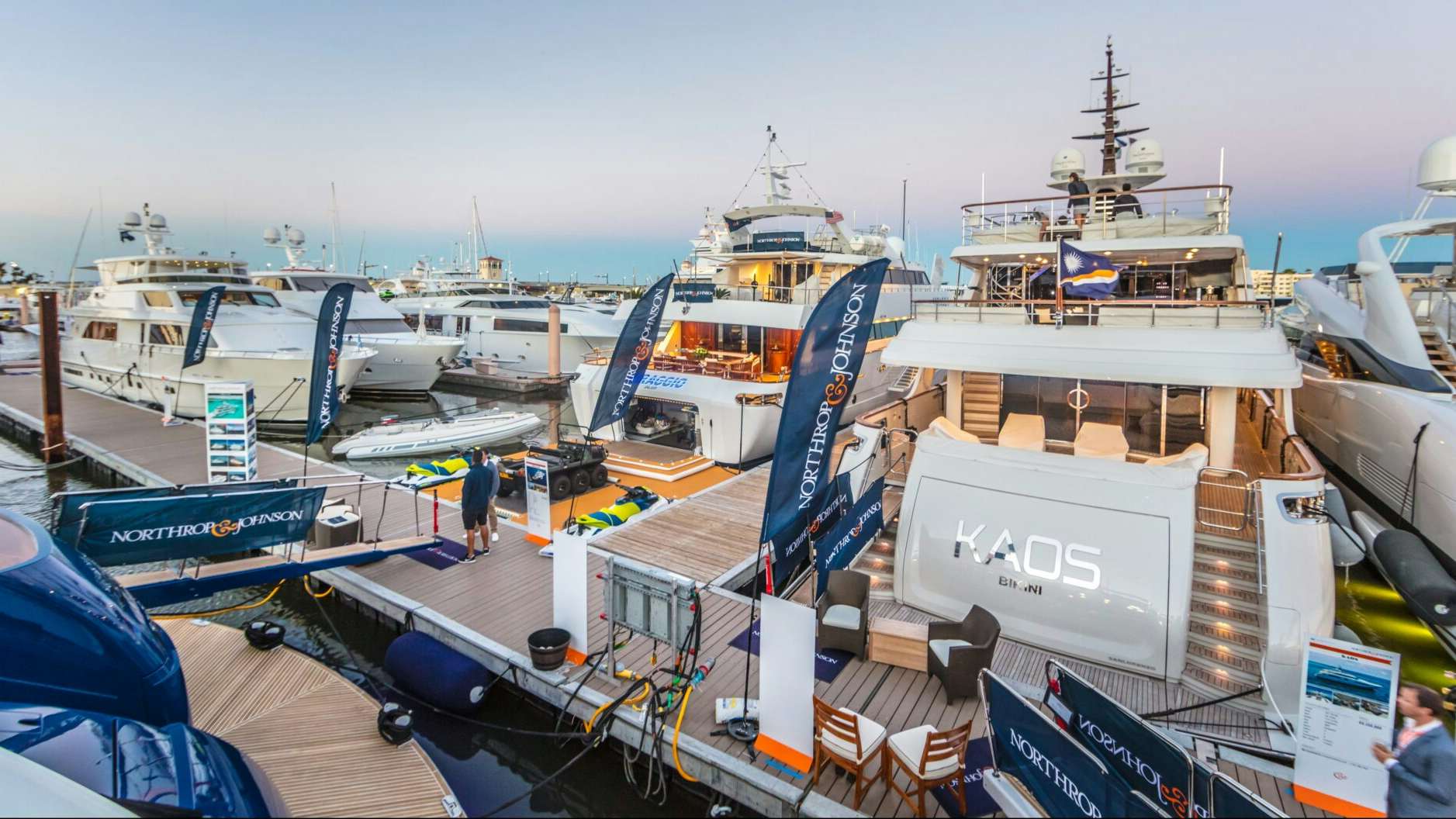 An aerial view capturing the sophistication of a Northrop & Johnson yacht showcased on the dock during the Palm Beach International Boat Show.