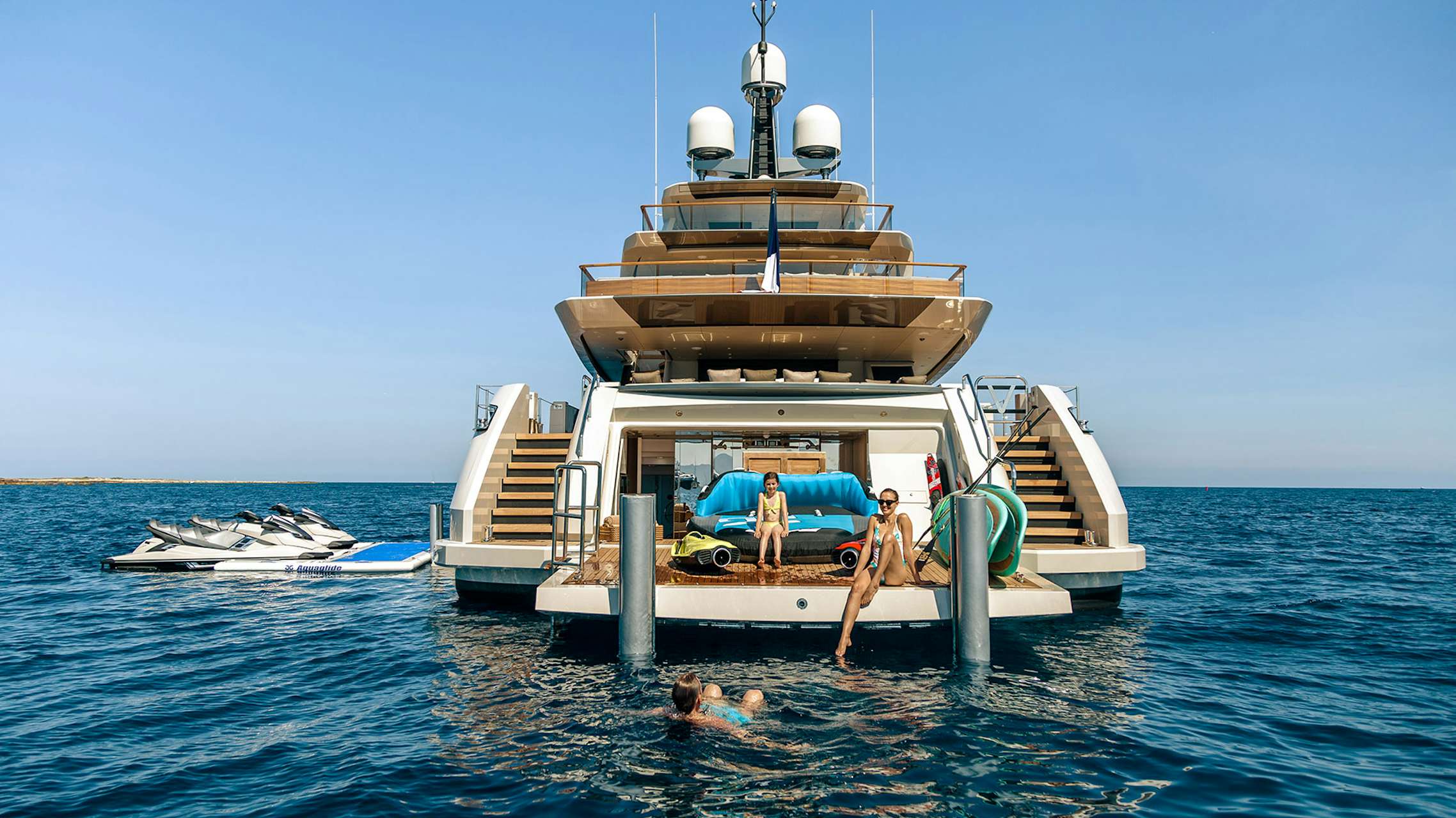 family having fun onboard luxury superyacht SOLO beach club in the mediterranean sea