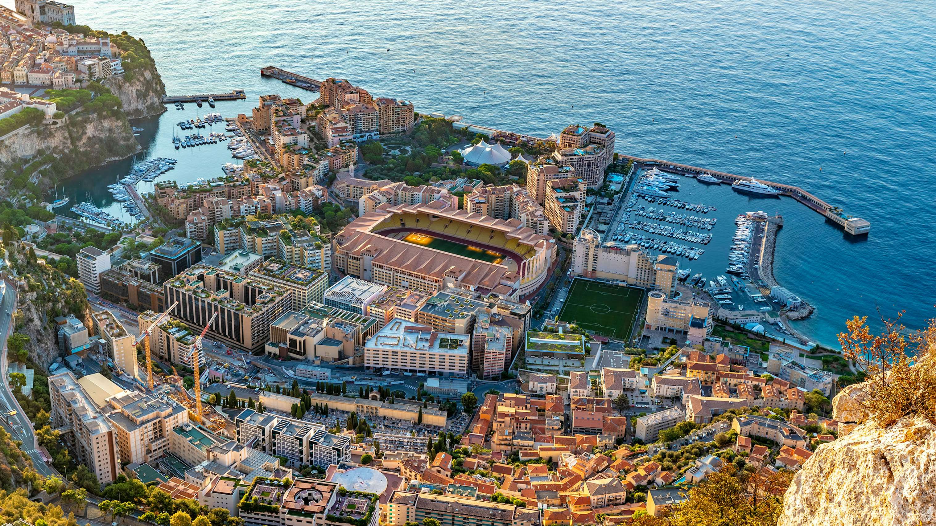 Panoramic view of Monte Carlo harbor filled with luxury yachts, encapsulating the essence of yacht charter in Monaco