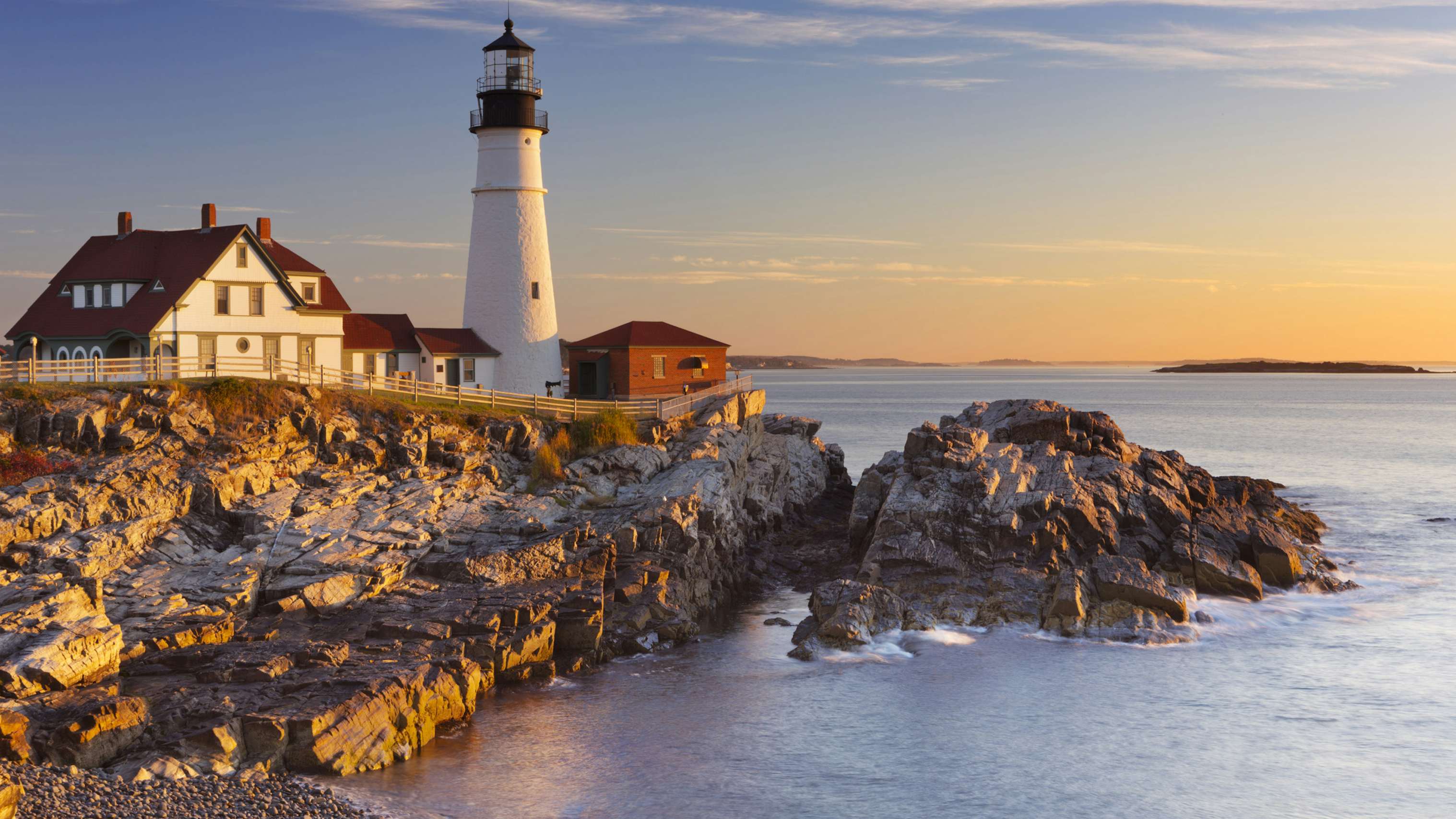 New England light house over the rocks and ocean