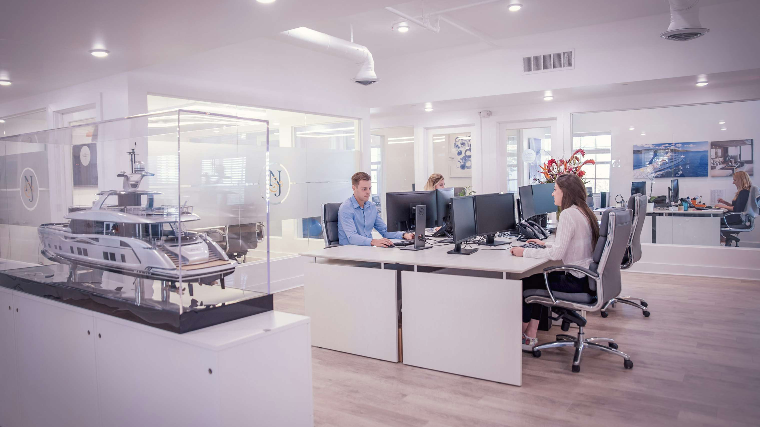 People working in open space desk at sleek | Modern Office for Yacht Charters | N&J