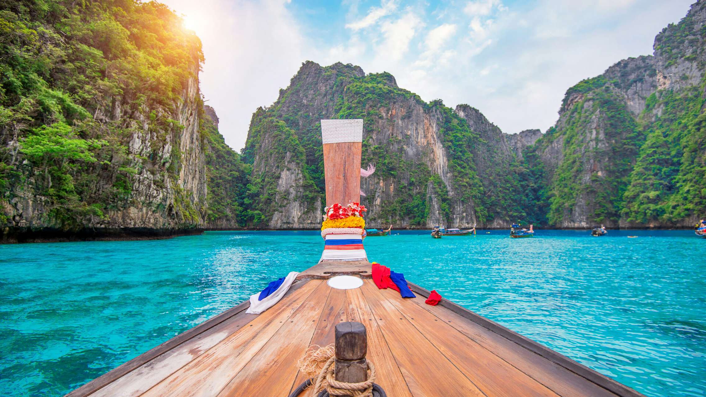 Asia Phi Phi islands wooden boat in blue water with green mountains