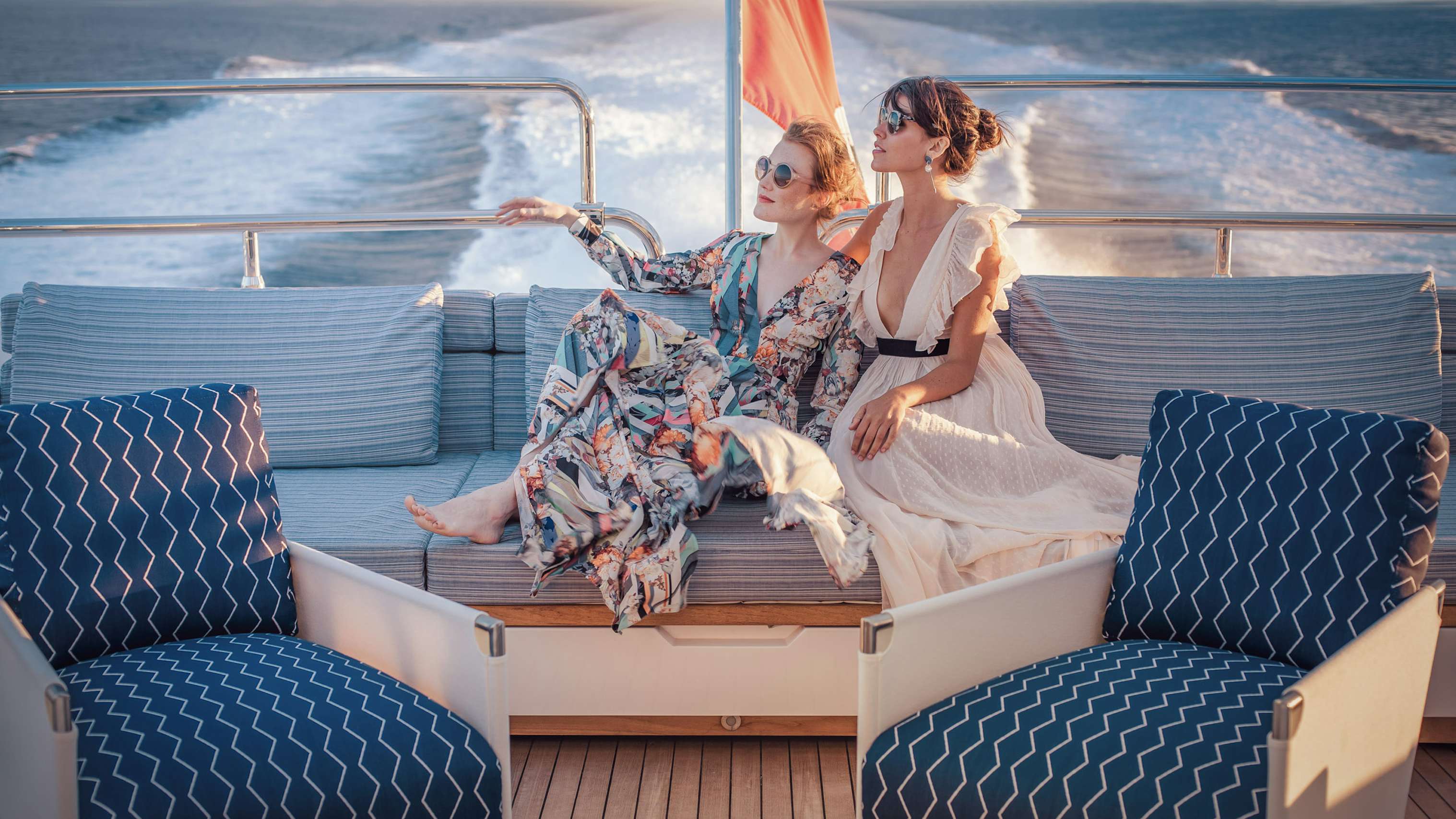 Two women sitting on the sundeck while underway