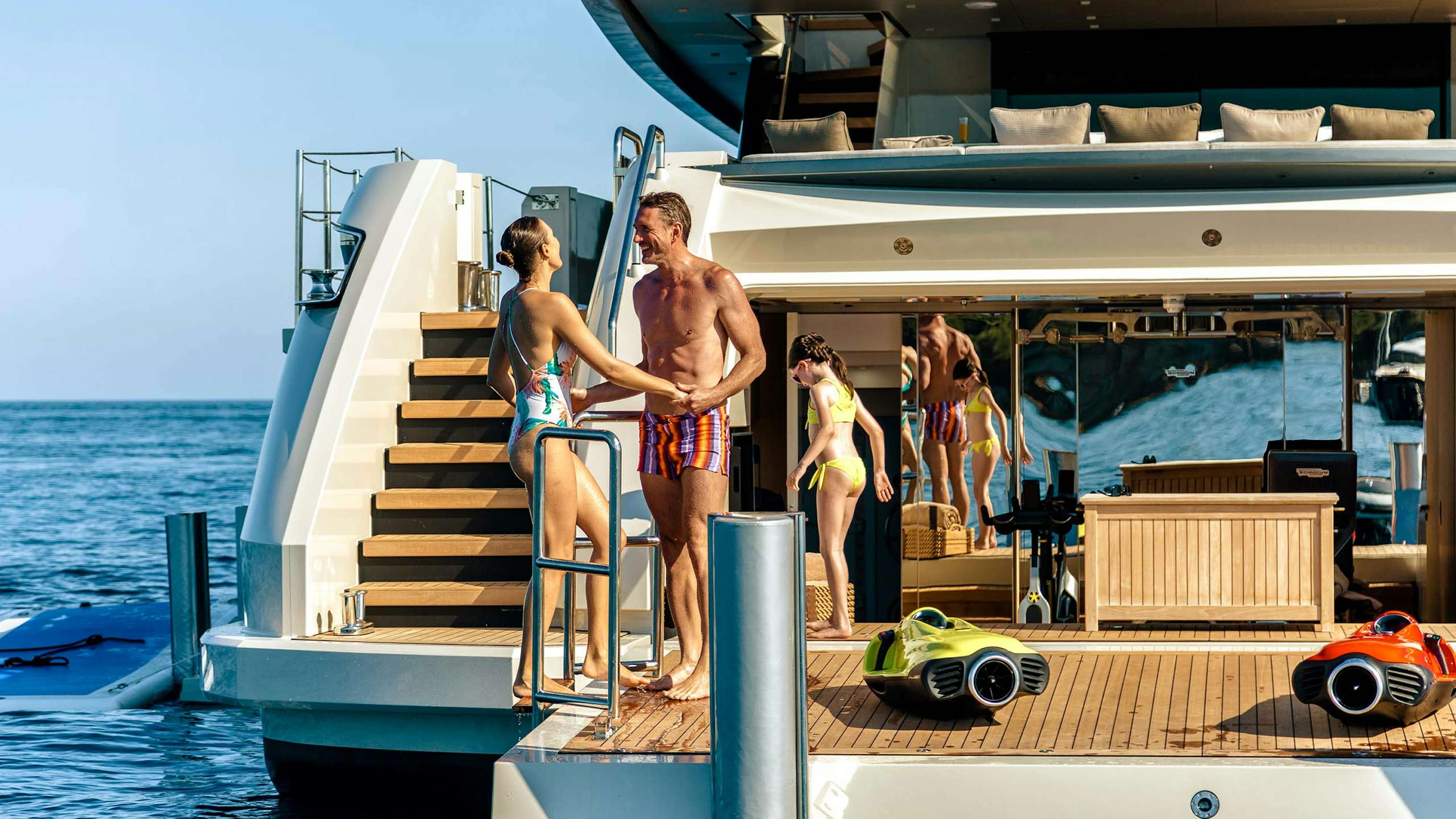 Family enjoying the beach club on board yacht for charter